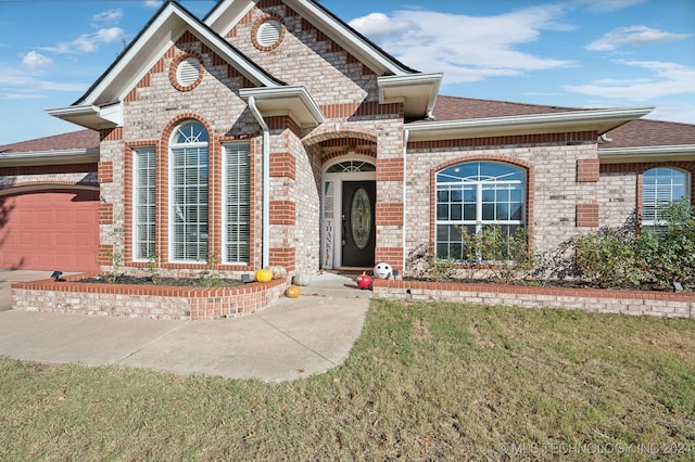 view of front of property with a garage and a front yard