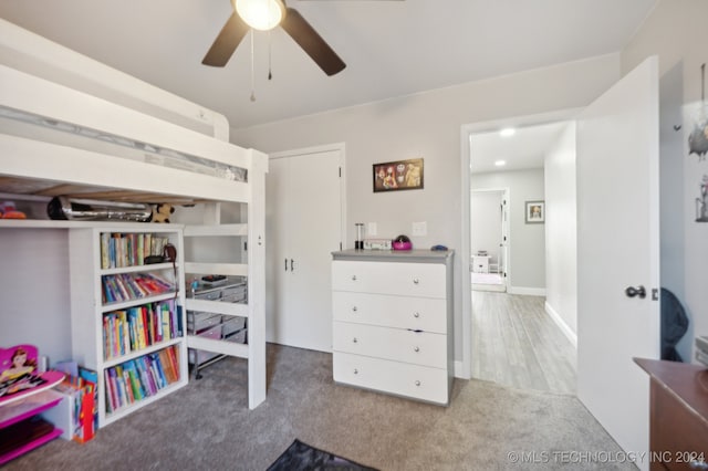 carpeted home office with ceiling fan