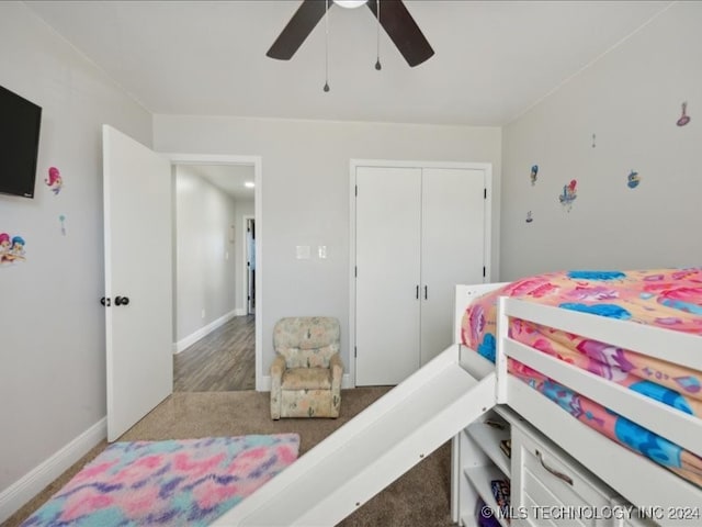 bedroom with a closet, hardwood / wood-style flooring, and ceiling fan