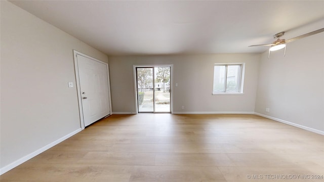 spare room featuring light wood-type flooring and ceiling fan