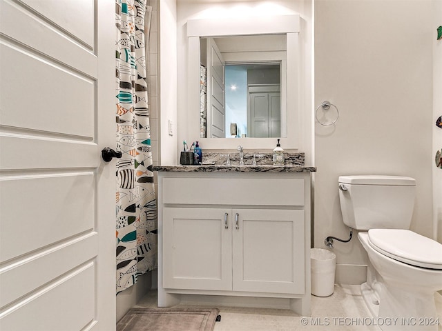 bathroom featuring vanity, toilet, and walk in shower