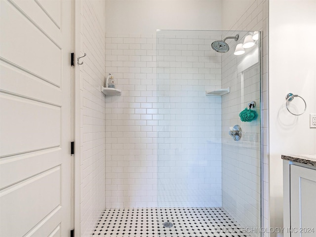 bathroom featuring vanity and a tile shower