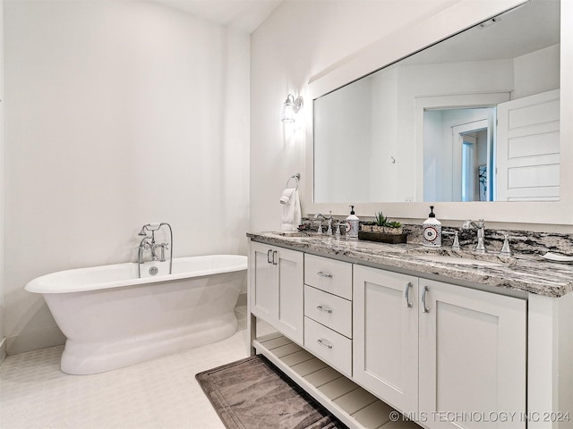 bathroom with vanity and a tub