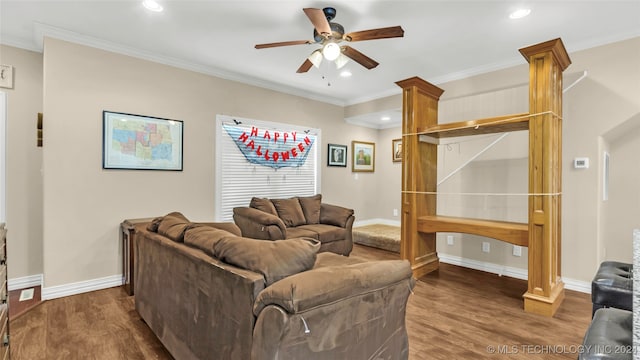 living room with ornamental molding, decorative columns, ceiling fan, and dark hardwood / wood-style flooring