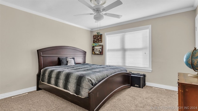 carpeted bedroom with ceiling fan and crown molding