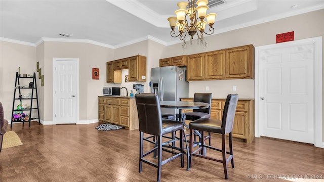 dining room with a chandelier, crown molding, and dark hardwood / wood-style flooring