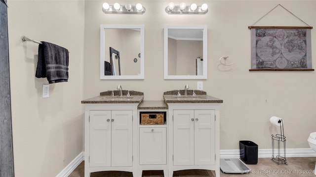 bathroom featuring toilet and vanity