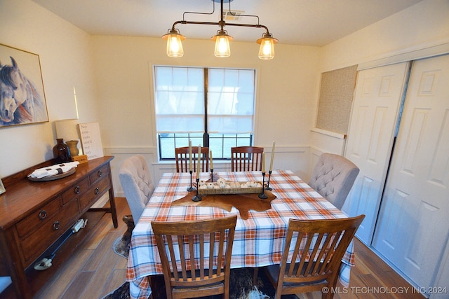 dining area with an inviting chandelier and dark hardwood / wood-style floors