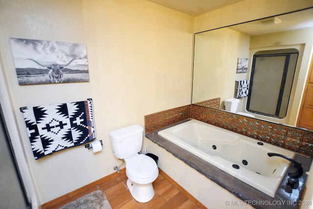 bathroom featuring hardwood / wood-style floors, a bathtub, and toilet