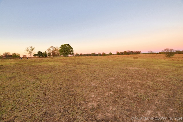 nature at dusk featuring a rural view