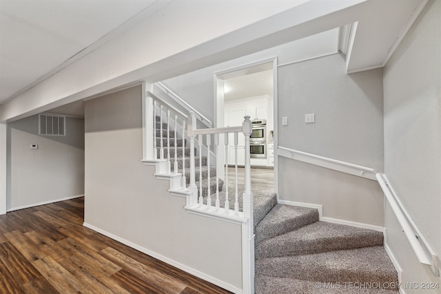 stairway featuring hardwood / wood-style flooring