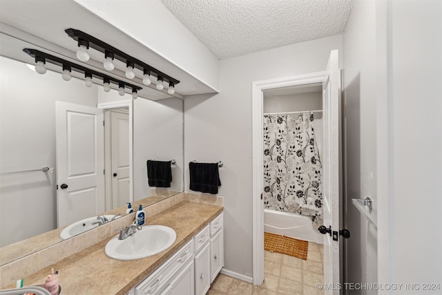 bathroom featuring vanity, a textured ceiling, and shower / bathtub combination with curtain