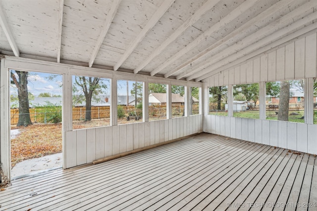 unfurnished sunroom with lofted ceiling