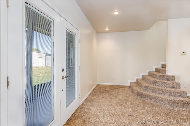 doorway to outside featuring carpet flooring, baseboards, stairs, and recessed lighting