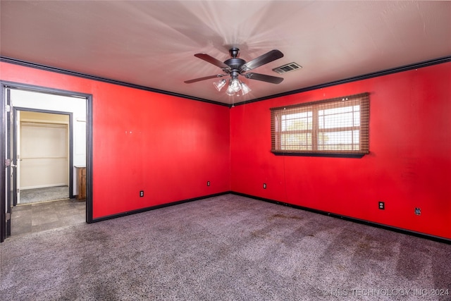 carpeted spare room with ceiling fan, baseboards, and crown molding