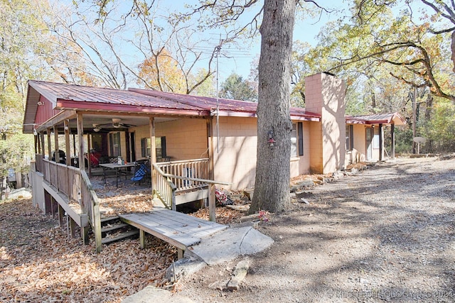 rear view of property with ceiling fan