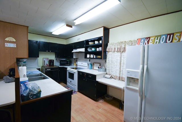 kitchen featuring light wood-type flooring, white appliances, and sink