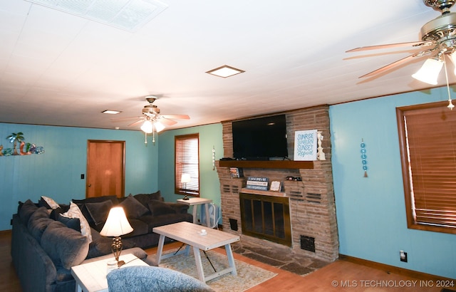 living room with a fireplace, hardwood / wood-style flooring, and ceiling fan