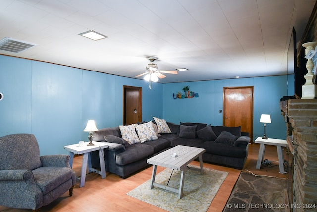 living room featuring light wood-type flooring and ceiling fan