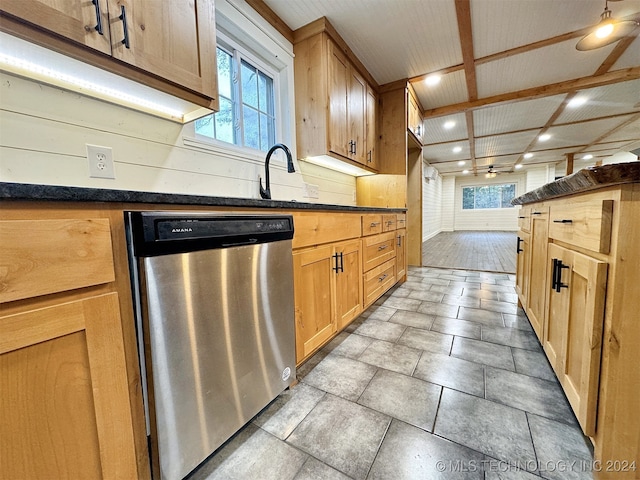 kitchen with beamed ceiling, stainless steel dishwasher, and sink