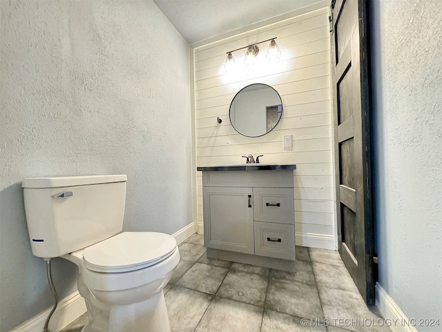 bathroom with vanity, tile patterned floors, and toilet