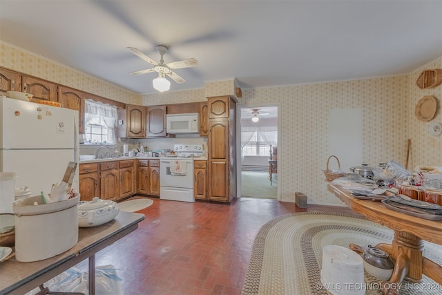 kitchen with white appliances, ceiling fan, sink, and crown molding