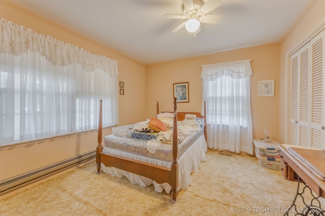 bedroom with ceiling fan, a closet, crown molding, and light colored carpet