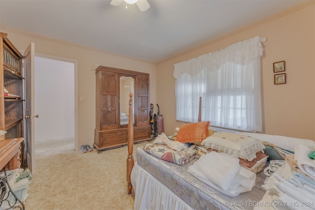 bedroom featuring ceiling fan, light carpet, and crown molding