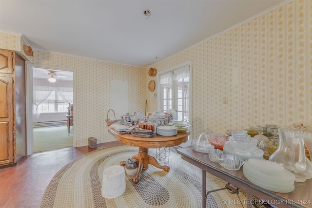 dining area with ceiling fan and crown molding