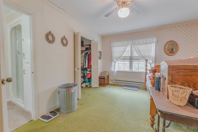 interior space with a baseboard heating unit, carpet floors, ceiling fan, and crown molding