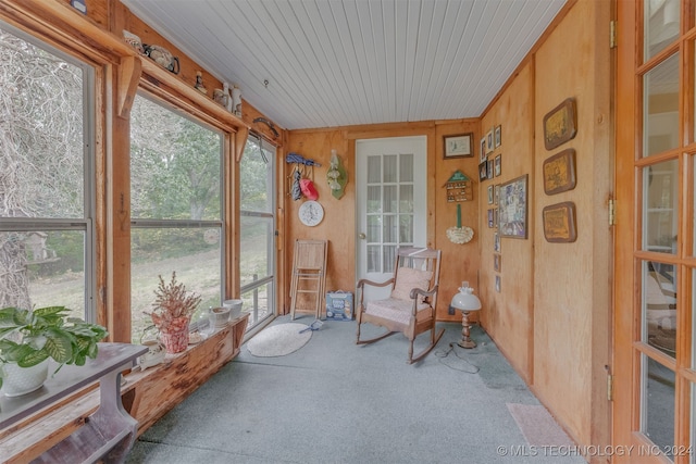 sunroom with wood ceiling and a healthy amount of sunlight