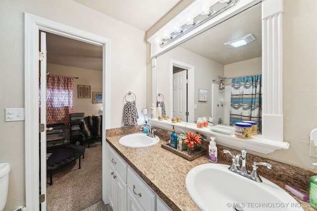 bathroom featuring vanity and toilet