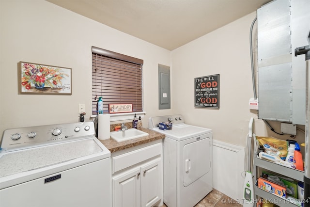 laundry room with cabinets, separate washer and dryer, sink, and electric panel