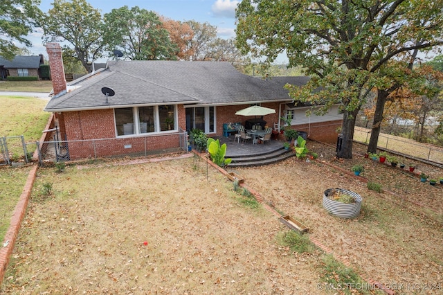 ranch-style house with a front lawn and a patio