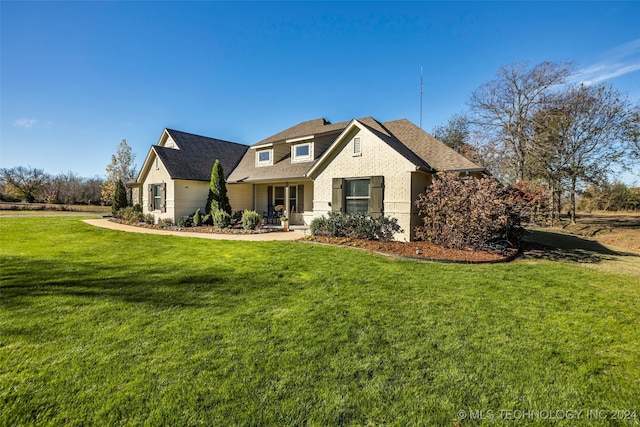 view of front of home with covered porch and a front lawn