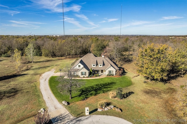 view of subject property with a heavily wooded area
