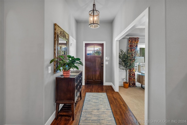 foyer with baseboards and dark wood-style floors