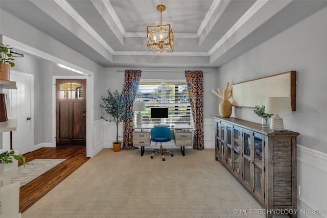 office area with a raised ceiling, wainscoting, a decorative wall, a chandelier, and ornamental molding