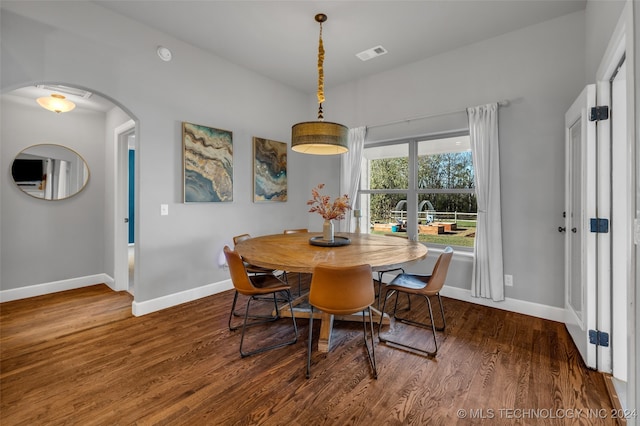 dining space with dark wood-type flooring