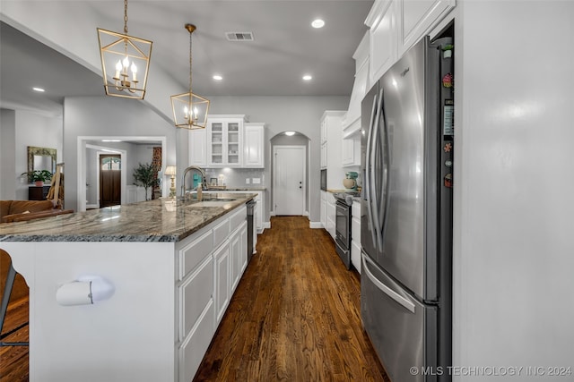 kitchen featuring appliances with stainless steel finishes, white cabinetry, hanging light fixtures, and sink