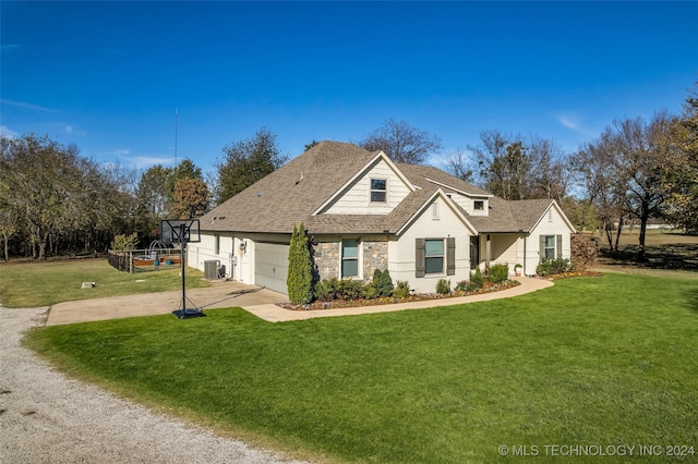 view of front of house with central AC unit, a front yard, and a garage