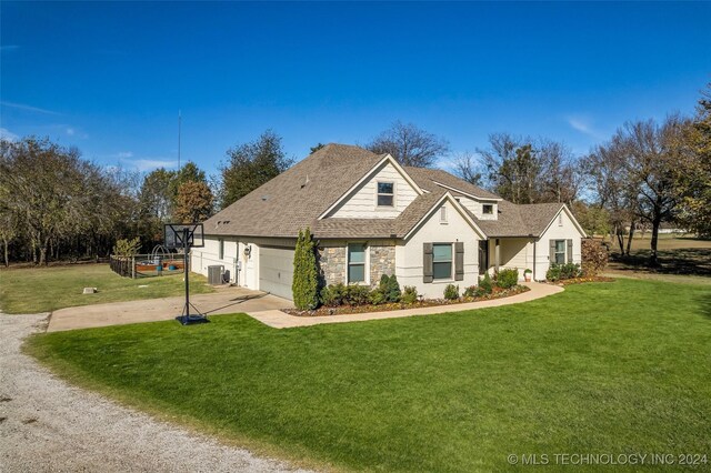 view of front of property with stone siding, driveway, a front yard, and an attached garage