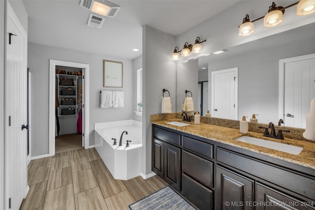 bathroom with vanity and a tub to relax in