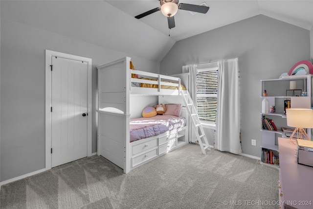 carpeted bedroom with ceiling fan and vaulted ceiling