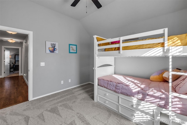 bedroom featuring carpet flooring, lofted ceiling, baseboards, and a ceiling fan