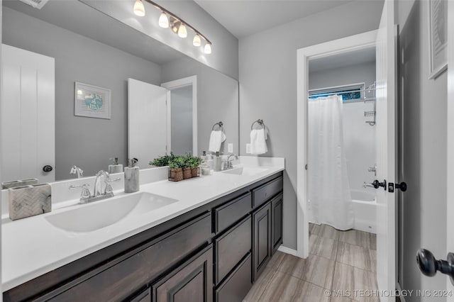 full bathroom with double vanity and shower / tub combo