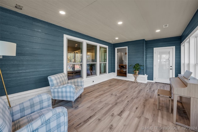 interior space with wood walls and hardwood / wood-style floors