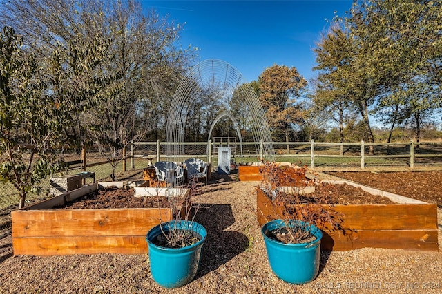view of yard featuring fence and a garden