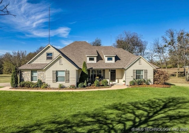 view of front of home with a front lawn and a shingled roof