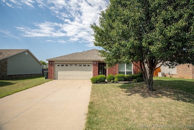 view of front of home with a garage and a front lawn